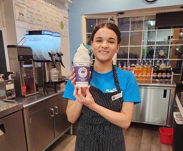 One of our staff holding an ice cream cone she just made