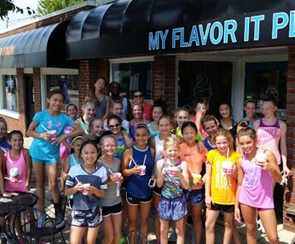 A group of kids outside our ice cream shop